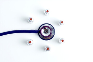 Medical layout on white background, flat. stethoscope or phonendoscope, vaccine vial bottle, syringe copy space, space for text. white isolation medical equipment.
