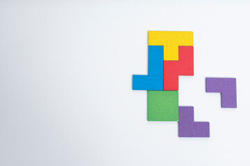 Fototapeta premium Geometric shape block with colorful wood puzzle piece background. logical thinking, business logic, Conundrum, decision, solutions, rational, mission, success, goals and strategy concepts. 