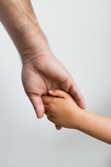 Adult and child holding hands. Connection, support, care. Fathers day concept