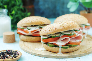 Bun sandwiches with salami and vegetables