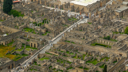 Aerial view of the archaeological park of Pompeii, located in the province of Naples, Campania, Italy. It is famous for the remains and ruins of the palaces and houses of an ancient Roman city.