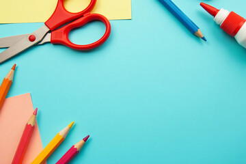 Flatlay of Colorful School Supplies on Teal Background representing Creativity and Education