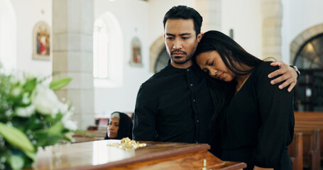 Death, comfort or couple mourning at funeral in church for respect, support or embrace for loss...