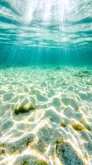 Fototapeta premium Underwater view with sun rays shining through turquoise water, sandy seabed
