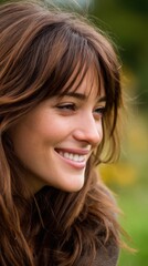 Portrait of a smiling brunette woman in profile with natural light and bokeh backdrop representing wellness beauty and lifestyle