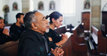 Religion, praying and man in church with family for christian service with congregation. Worship, spiritual guidance and senior person with prayer for hope, faith or respect with gospel in chapel.