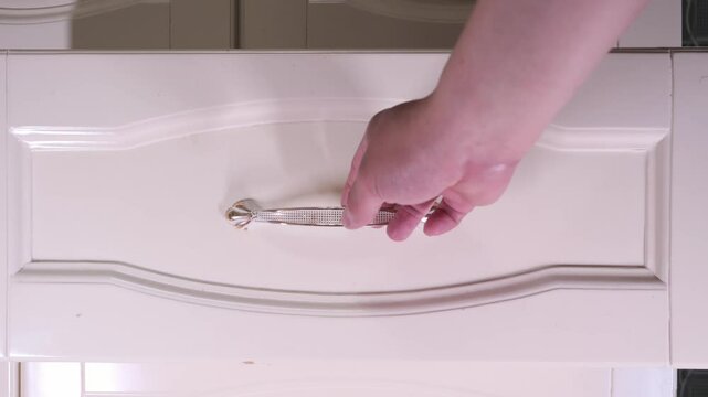 Opening a drawer and taking out an item in slow motion, home life concept theme