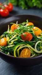Zucchini Noodle Salad with Spinach and Tomatoes in Dark Bowl on Slate Surface
