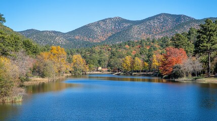 Autumnal landscape of a serene lake nestled amongst mountains.