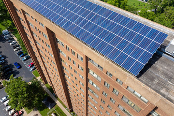Photovoltaic panels on solar rooftop of condo building for producing clean ecological electrical...