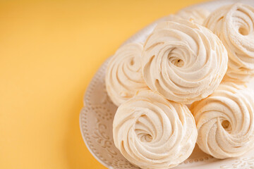 Homemade mango marshmallow on a plate with orange background