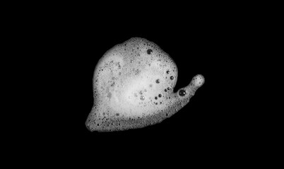 White foam isolated, Top view white foam soap or shower gel isolated on a black background. White facial foam creamy bubble soap sponge isolated on black background.