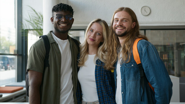 Portrait in university school college group happy multiracial three students diversity people young friends together smiling community looking at camera Caucasian woman girl African American men guys