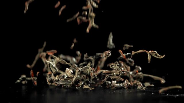 Dry tea falls on the table. Filmed on a high-speed camera at 1000 fps. High quality FullHD footage