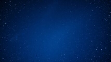 Fototapeta premium A deep blue night sky background image features countless twinkling stars scattered across the vast expanse.