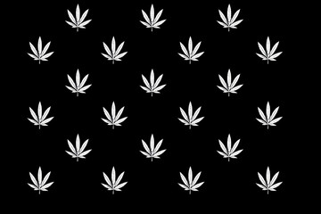A pattern of cannabis leaves on a black background