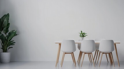 Modern Minimalist Dining Room with White Chairs and Green Plant on Table Against Neutral Wall