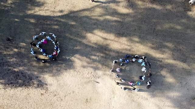 
Group of countrywomen and gauchos in traditional dress dancing Argentine folklore
