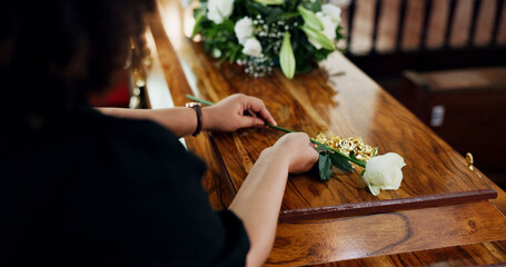 Hands, woman and rose at funeral for farewell, mourning death and goodbye at burial ceremony. Sad,...