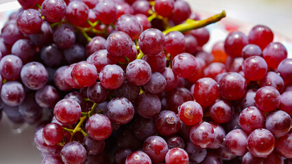 Close up of raw organic sweet red grapes background.