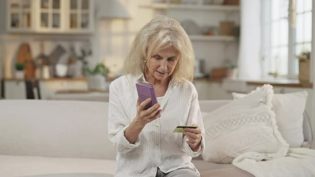 Data theft and fraud with credit card, aged woman talking with scammers by phone . Portrait of mature lady reporting data of bank card, feel shock and frustration, emotional grandmother, money steal