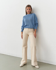 Fashion model poses elegantly in a modern studio showcasing contemporary style
