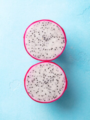 Fresh dragon fruit, pitahaya. Blue background. Top view.
