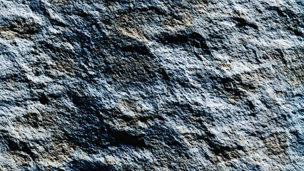 The texture of natural stone is light gray. Grunge dark mineral rock closeup pattern. Natural macro stone texture.