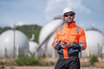 Environmental engineer or workers examining waste water along a  large industrial waste water or pollution monitoring and maintenance to ensure systems operate effective environmental regulations.