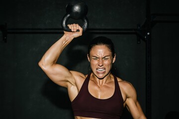 Strong Woman Lifting Kettlebell With