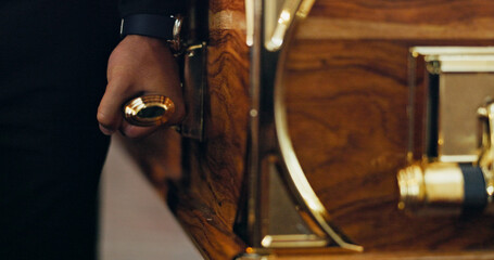 Funeral, carry or hands of person with coffin in church for farewell service, mourning death or...