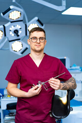 Surgeon gets ready for surgery. Surgeon stands in a modern operating room, holding surgical tools...