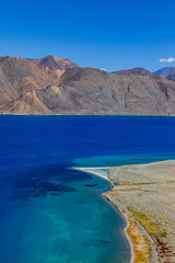 Fototapeta premium Landscape with mountains on the lake named Pagong Tso or Pagong Lake, situated on the border with India and China, Leh, Ladakh, India. one of the world's highest brackish water lake