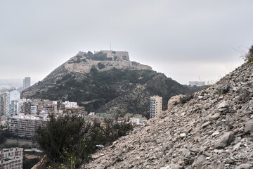 Alicante's santa barbara castle overlooking urban landscape on cloudy day