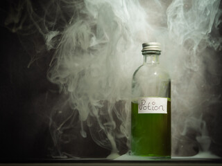 Witches potion in a bottle with smoke close up shot 