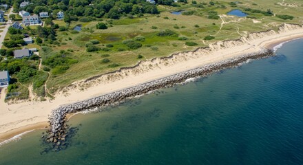 Coastal shoreline with sandy beach and breakwater