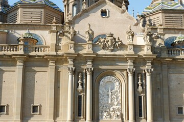 Intricate stone carvings and sculptures adorn the facade of a historic building in Zaragoza, Aragon, Spain