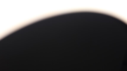 Abstract blurred light source on a dark background, creating a soft glow and a sense of mystery or...