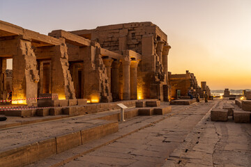Magnificent temple of Sobek and Horus at Kom Ombo as the sun sets over the river Nile