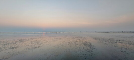 Serene Sunset over Coastal Flats Peaceful Ocean Landscape at Low Tide
