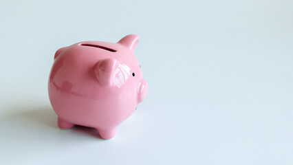 Piggy bank on a plain background showcasing savings and personal finance habits for budgeting