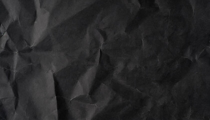Crumpled paper background. Black paper texture background. High-resolution wrinkled paper surface for design, grunge, or abstract projects.