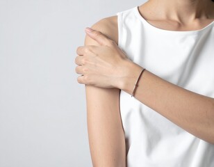 A woman with long, flowing hair is wearing a stylish armband, gently resting her hand on her wrist, showcasing the accessory's intricate design.