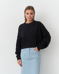 Elegant model showcasing modern fashion in a chic studio setting during a photoshoot