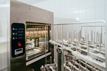 Milk sterilizer in lab with detached racks in foreground