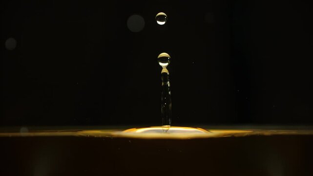 Cosmetics golden serum liquid. Falling drop macro abstract background. Cosmetic moisturizer essence gel. Collagen fluid bubble molecule. Yellow moisturizing cream oil. Beauty skin health care concept