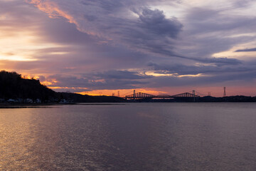 Panorama of the Pierre-Laporte and Quebec bridges in silhouette against a dramatic purple sunrise...