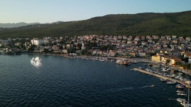 sea and city on a hillside, it is with harbor filled with boats, the weather is sunny with clear sky