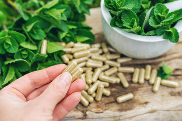 Peppermint extract essential oil and supplements. Selective focus.