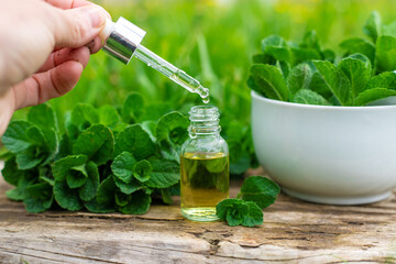 Peppermint extract essential oil and supplements. Selective focus.